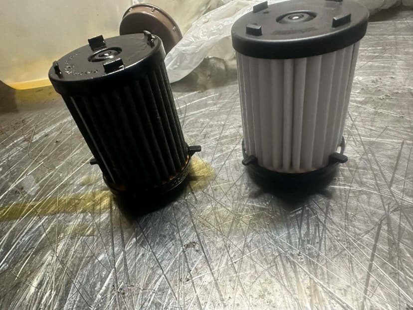 Porównanie filtrów: stary zatkany czarny vs nowy biały filtr mechatroniki 0CK